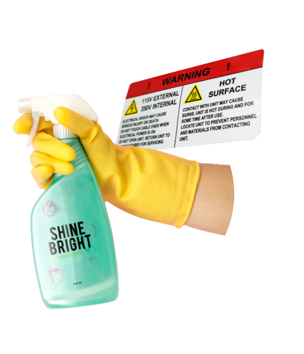 Spray bottle being held by a yellow cleaning glove