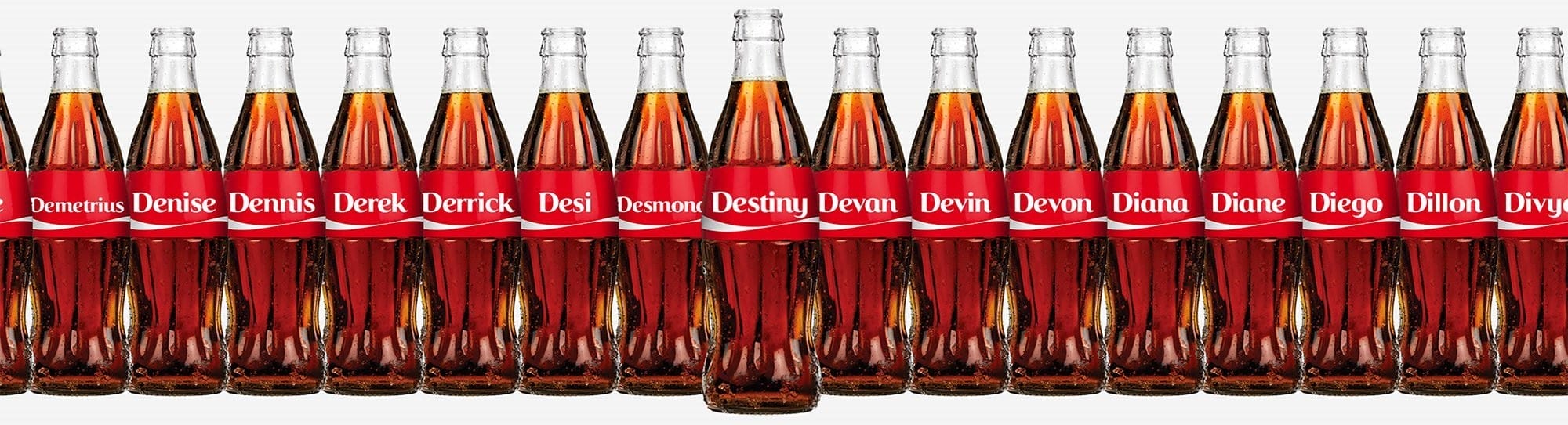 Coke bottles in a row with names on the labels