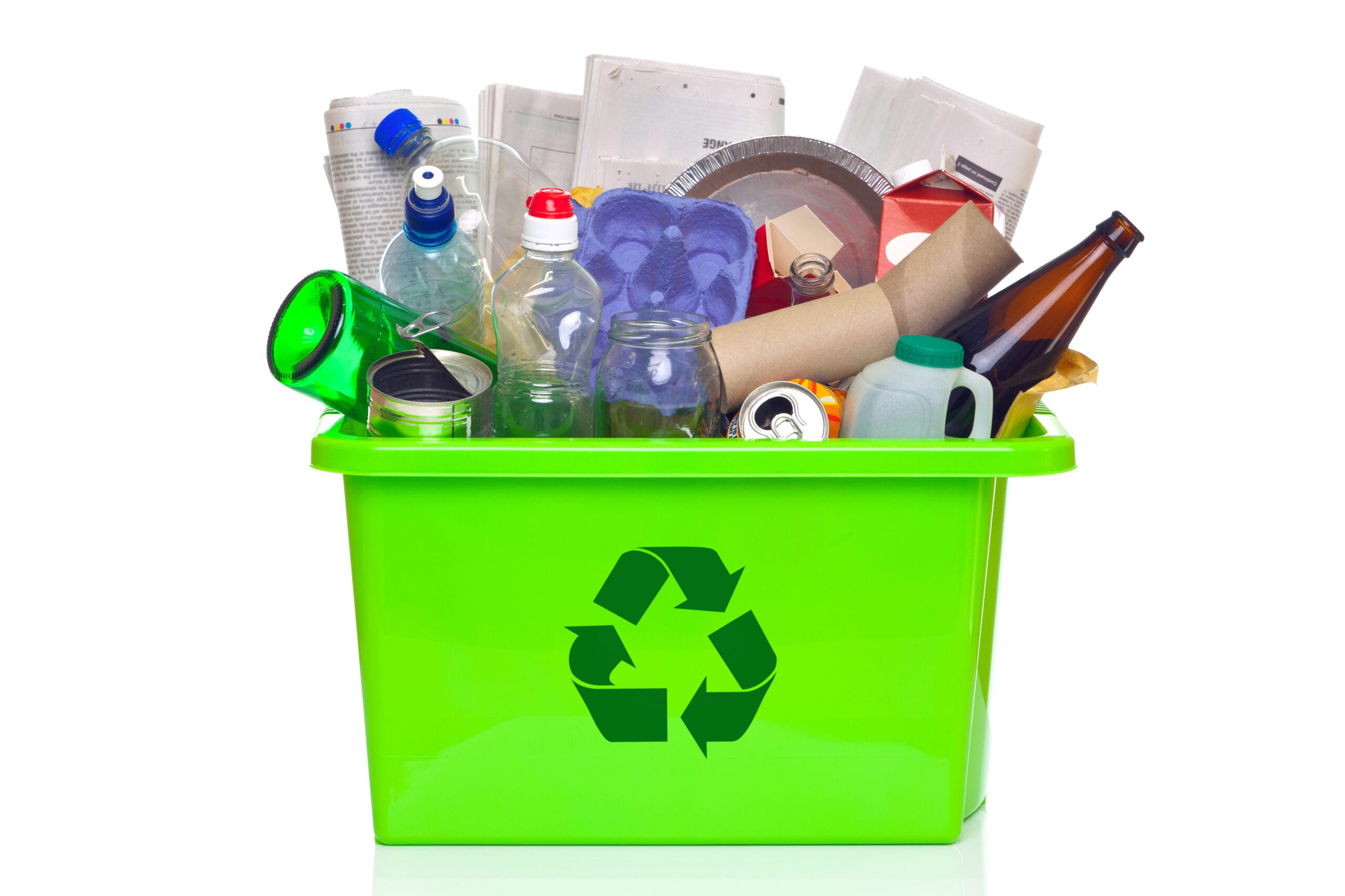 Photo of a green recycling bin full of recyclable items isolated on a white background.