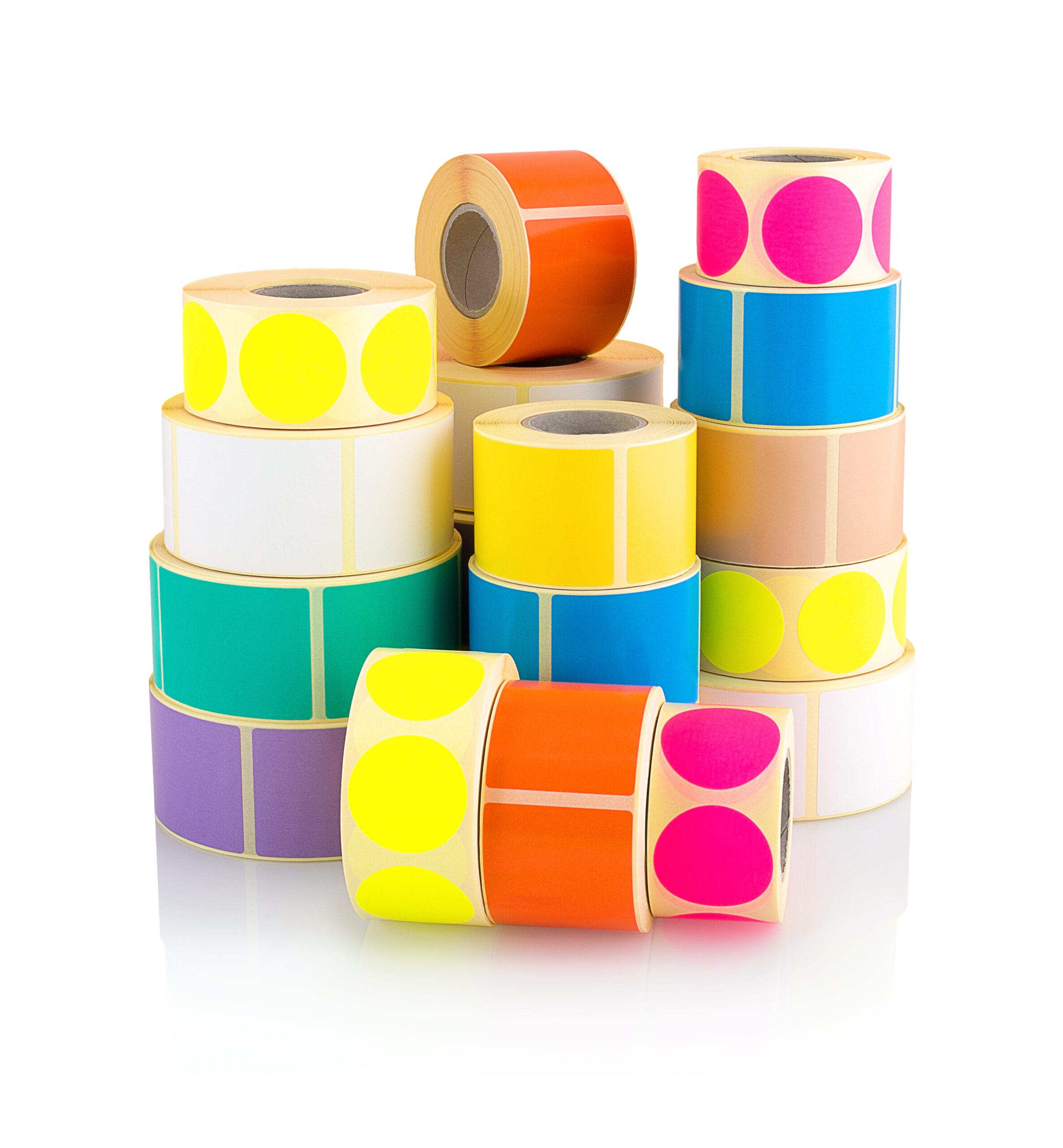 Colored label rolls isolated on white background with shadow reflection.