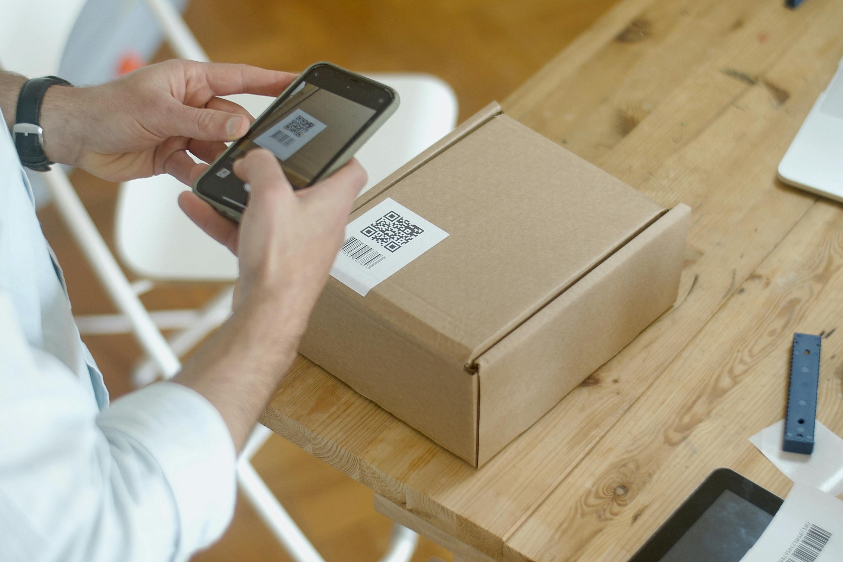 Smartphone scanning a QR code on a product label for authentication, using brand colors #3CB4E5, #0A5776, and #404040 - how do i secure my brand label